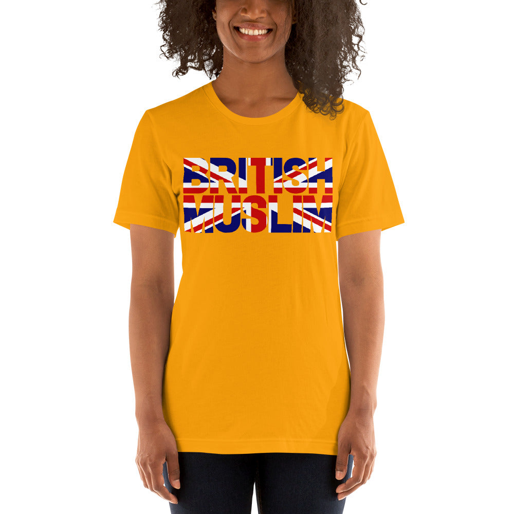 A woman wearing a Gold/ Yellow coloured Unisex T-shirt with the text saying BRITISH MUSLIM that is also in the colours of the british flag.
