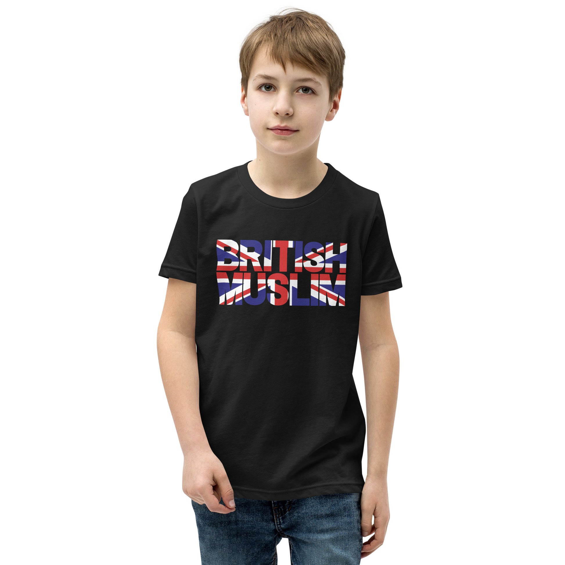 A boy wearing a black coloured Unisex T-shirt with the text saying BRITISH MUSLIM that is also in the colours of the british flag.