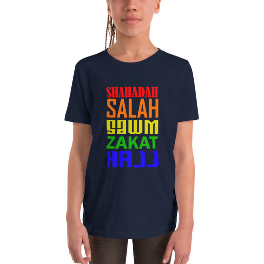 A girl wearing a navy coloured kids Unisex T-shirt with the text saying the 5 pillars of islam in different colours.